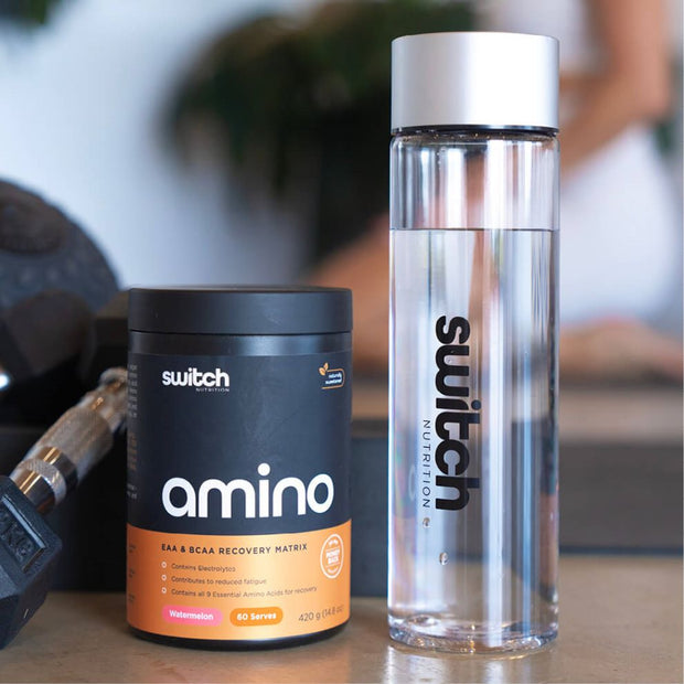 A close-up of a Switch Nutrition amino acid supplement tub with &