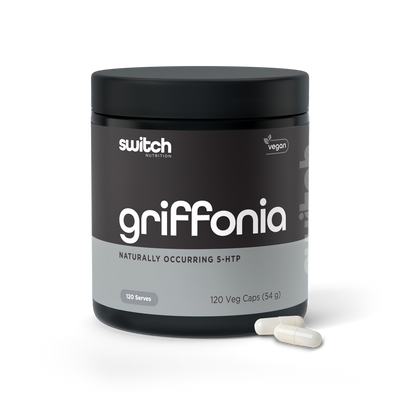 A container of Switch Nutrition Griffonia, a vegan product containing naturally occurring 5-HTP, with 120 vegetable capsules amounting to 54 grams in total, displayed alongside two white capsules in front of the container.