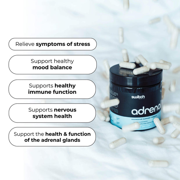 An image of a Switch Nutrition "adrenal" magnesium supplement container surrounded by capsules on white bedding. Text bubbles list benefits for stress relief, mood, immune and nervous system health, and adrenal support.
