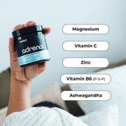 The image displays a person's hand holding a container of Switch Nutrition 'adrenal' supplement with text bubbles listing ingredients: Magnesium, Vitamin C, Zinc, Vitamin B6 (P-5-P), and Ashwagandha.