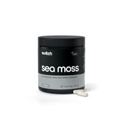A product image featuring a compact, black container with "sea moss" in bold, white lettering from Switch Nutrition. Below, in smaller font, reads "organic sea moss extract." The container appears to be of high quality with a minimalist design, and a single capsule is visible in the foreground, suggesting the product is a dietary supplement. The background is white, highlighting the clean and simple aesthetic of the product's packaging