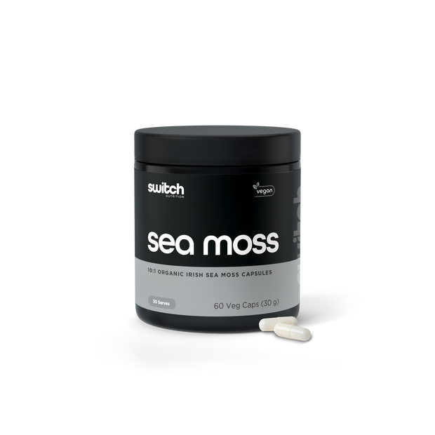 A product image featuring a compact, black container with "sea moss" in bold, white lettering from Switch Nutrition. Below, in smaller font, reads "organic sea moss extract." The container appears to be of high quality with a minimalist design, and a single capsule is visible in the foreground, suggesting the product is a dietary supplement. The background is white, highlighting the clean and simple aesthetic of the product&