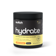 Switch Nutrition HYDRATE Electrolyte Rehydration Blend in Orange Crush Flavor, 150g container with 25 servings, displaying no added sugar or caffeine, and enriched with B-vitamins, taurine, and antioxidants, with a 60-day money-back guarantee seal.