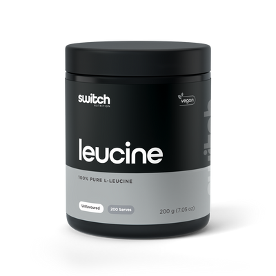 A container of Switch Nutrition's Leucine, featuring 100% pure L-Leucine, unflavoured, offering 200 serves per container. The packaging is black with white and green text, highlighting the vegan-friendly aspect of the supplement.