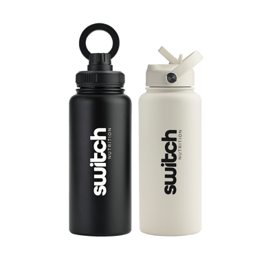 Two 1-litre stainless steel water bottles from Switch Nutrition. One bottle is matte black with a loop-top lid, while the other is matte white with a flip-top straw lid. Both feature the "Switch Nutrition" logo in bold black lettering.