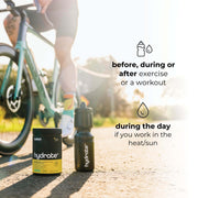 A container of 'HYDRATE+' by Switch Nutrition and a sports water bottle are placed on a sunlit road, with a cyclist in the background suggesting an active lifestyle. Text on the image recommends using the product before, during, or after exercise or a workout, and also during the day for those working in heat or sun. The image communicates the utility of the hydration product for athletes and outdoor workers.
