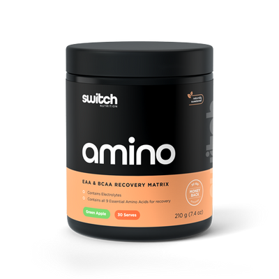 Container of Switch Nutrition's 'amino' in green apple flavor, an EAA & BCAA recovery matrix, which contains electrolytes and all 9 essential amino acids for recovery. The product is naturally sweetened, offers 30 servings, and the weight is 210 grams (7.4 oz) with a 30 day money back guarantee' emblem.